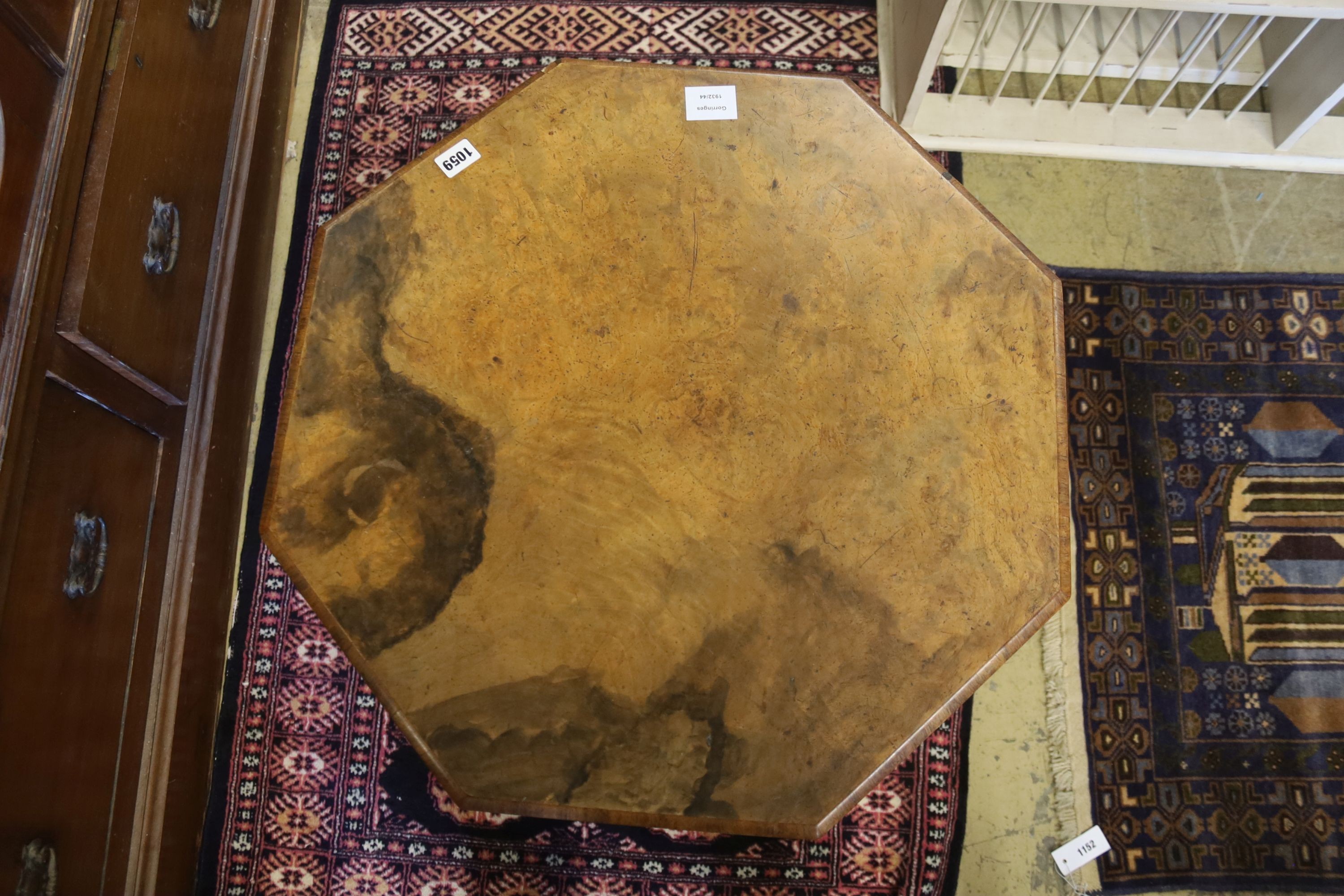 A Victorian burr walnut octagonal topped tea table, raised on leaf carved pillar and open scrolled cabriole tripod base, width 58cm, height 65cm